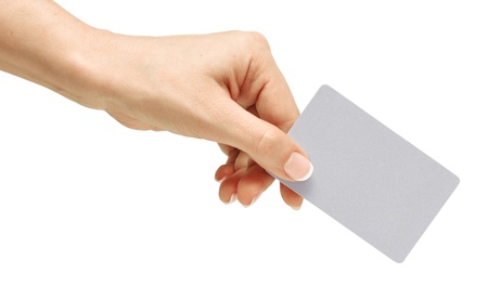 Business card in female hand. Studio isolated. With clipping pathの写真素材