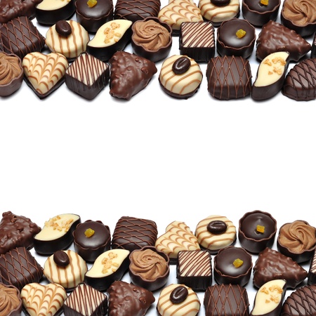 Border of Different chocolate candies over white backgroundの写真素材