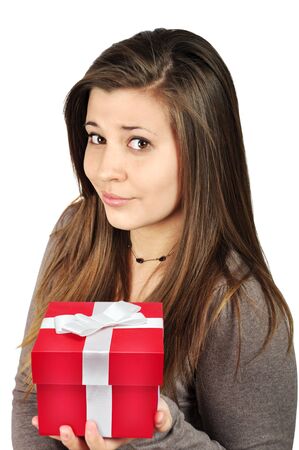Beautiful young girl with red gift box over white backgroundの写真素材