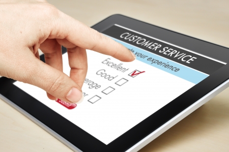 Online customer service satisfaction survey on a digital tabletの写真素材