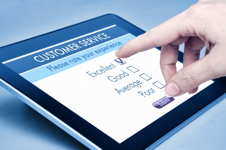 Online customer service satisfaction survey on a digital tabletの写真素材