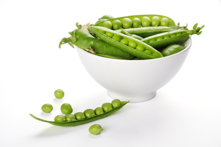 fresh green peas on a white bowl close upの写真素材