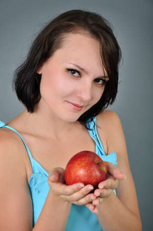picture of lovely young woman with apple in her handsの写真素材