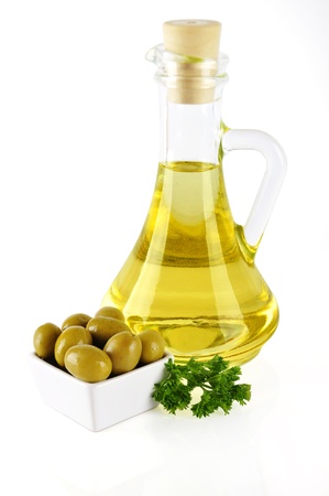 bottle of olive oil isolated on white with olives on small plateの写真素材
