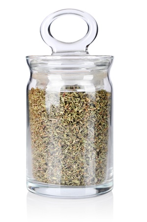 Dried savory in glass bottle isolated on white backgroundの写真素材