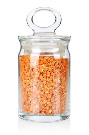 Dried carrots in glass bottle isolated on white backgroundの写真素材