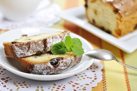 Weihnachtsstollen on white plate with cup of tea  Small shallow dof の写真素材