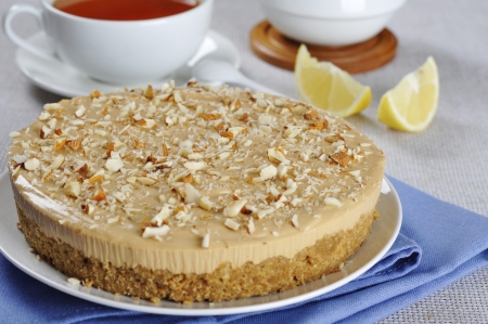 Homemade caramel cheesecake with almond on white plate  Small shallow DOFの写真素材