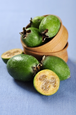 fresh ripe pineapple guava fruit on a blue tablecloth closeupの写真素材