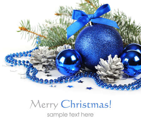 Blue christmas decorations and silver pine cones over white backgroundの写真素材