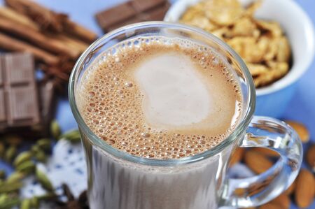 Cocoa in a glass cup closeup with chocolate and spicesの写真素材