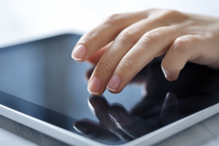closeup of finger touching screen on tablet-pc with shallow depth of fieldの写真素材