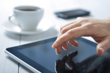 closeup of finger touching screen on tablet-pc with shallow depth of fieldの写真素材