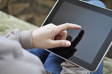 Woman using digital tablet PC  at homeの写真素材