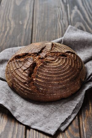 Bread with napkin on a wooden background closeupの写真素材