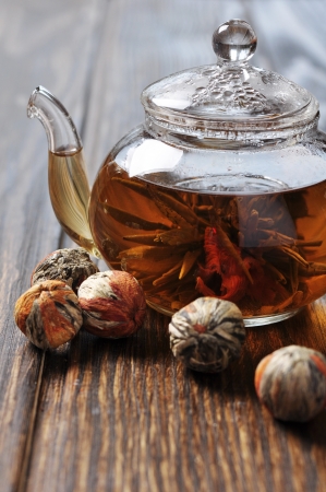 Chineas flowering tea in glass teapot on wooden backgroundの写真素材