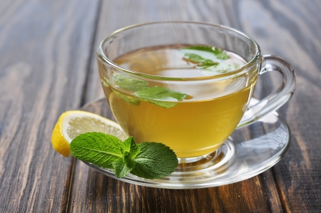 Cup of Herbal tea with lemon and mint on a wooden backgroundの写真素材