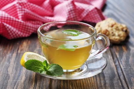 Herbal tea in cup  with mint and lemon  on wooden backgroundの写真素材