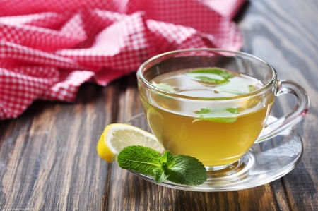Herbal tea in cup  with mint and lemon  on wooden backgroundの写真素材