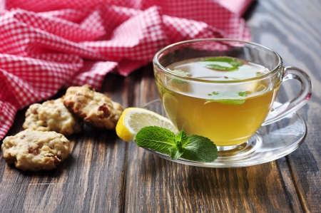 Herbal tea in cup  with mint and lemon  on wooden backgroundの写真素材