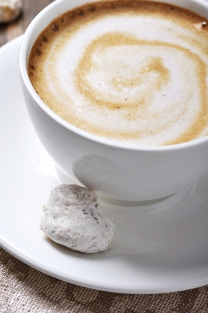 Cup of coffee with almond biscotti over wooden backgroundの写真素材