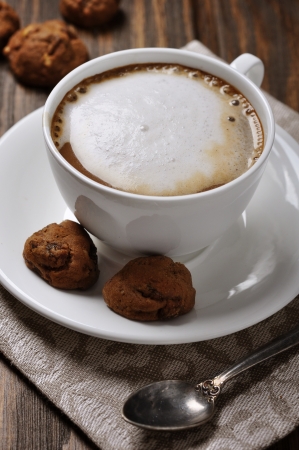 Cup of coffee with biscotti over wooden backgroundの写真素材