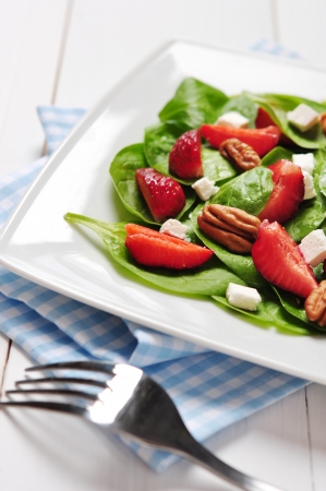 Spinach salad with strawberries, goat's cheese and pecan nutの写真素材