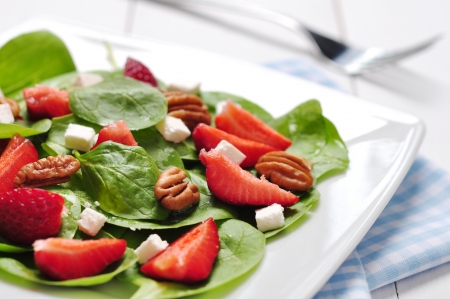 Spinach salad with strawberries, goat's cheese and pecan nutの写真素材