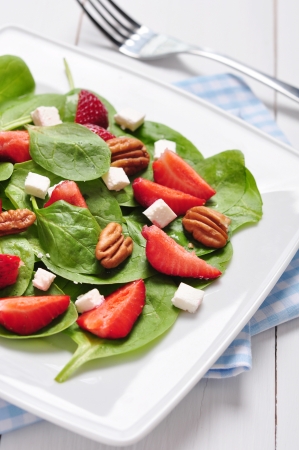 Spinach salad with strawberries, goat's cheese and pecan nutの写真素材
