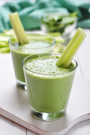 Green vegetable smoothie with celery and spinach on wooden backgroundの写真素材