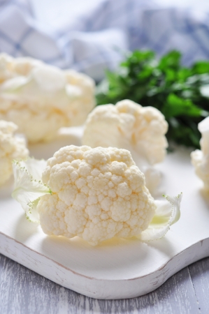 Close up on fresh cauliflower on cutting boardの写真素材