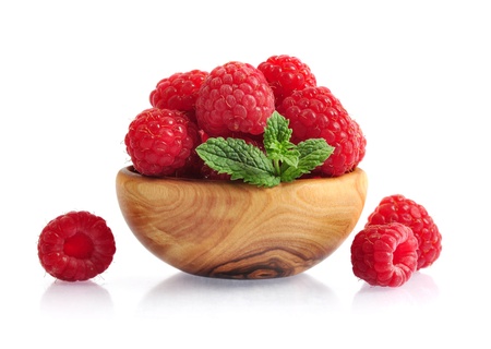 Fresh raspberry in wooden bowl isolated on whiteの写真素材