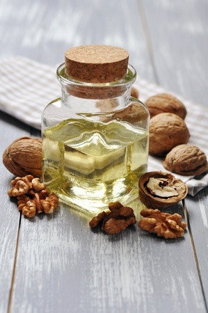 Walnut oil with nuts on a wooden backgroundの写真素材