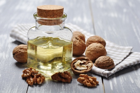 Walnut oil with nuts on a wooden backgroundの写真素材
