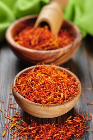 Saffron in wooden bowl on wooden backgroundの写真素材
