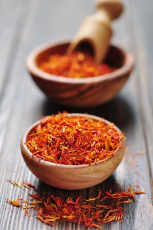 Saffron in wooden bowl on wooden backgroundの写真素材