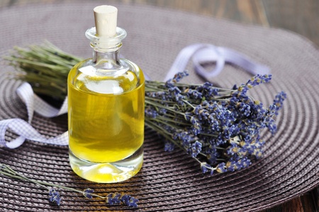 essential lavender oil with fresh flowers on wooden の写真素材