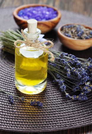 essential lavender oil with fresh flowers on wooden background. selective focusの写真素材