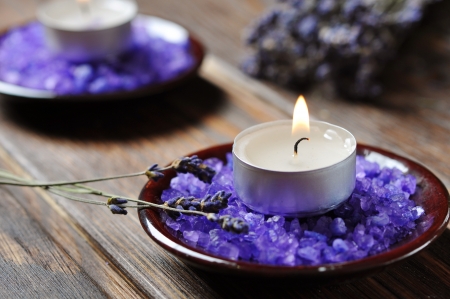 Spa background, candle with salt baths and sprigs of lavenderの写真素材