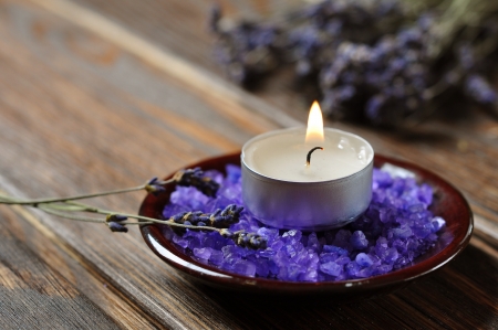 Spa background, candle with salt baths and sprigs of lavenderの写真素材