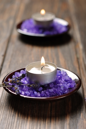 Spa background, candle with salt baths and sprigs of lavenderの写真素材
