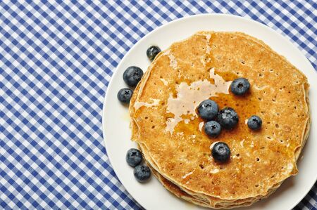 Delicious pancakes with fresh blueberries and maple syrupの写真素材