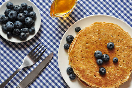 Delicious pancakes with fresh blueberries and maple syrupの写真素材