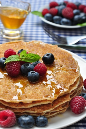 Delicious pancakes close up, with fresh blueberries, raspberry and maple syrup
pancakes with fresh berriesの写真素材