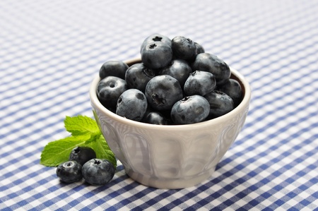 bowl of blueberries on blue checkered backgroundの写真素材