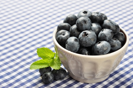 bowl of blueberries on blue checkered backgroundの写真素材