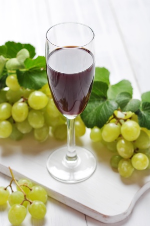 Red wine and grapes on wooden backgroundの写真素材