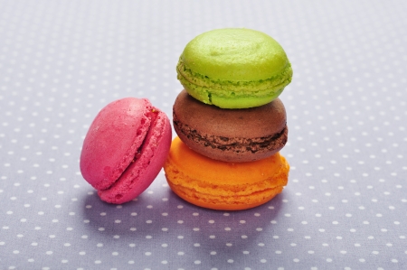 Colorful macaroons over violet polka dot backgroundの写真素材