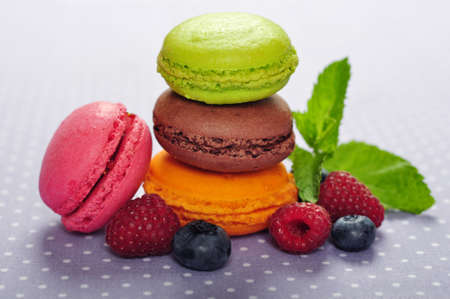 Colorful macaroons with fresh berries and mintの写真素材