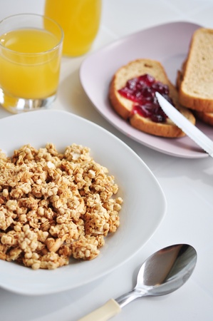wholegrain muesli breakfast with orange juice and bread with jamの写真素材